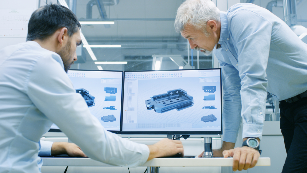 Industrial,Designer,Has,Conversation,With,Senior,Engineer,While,Working,In